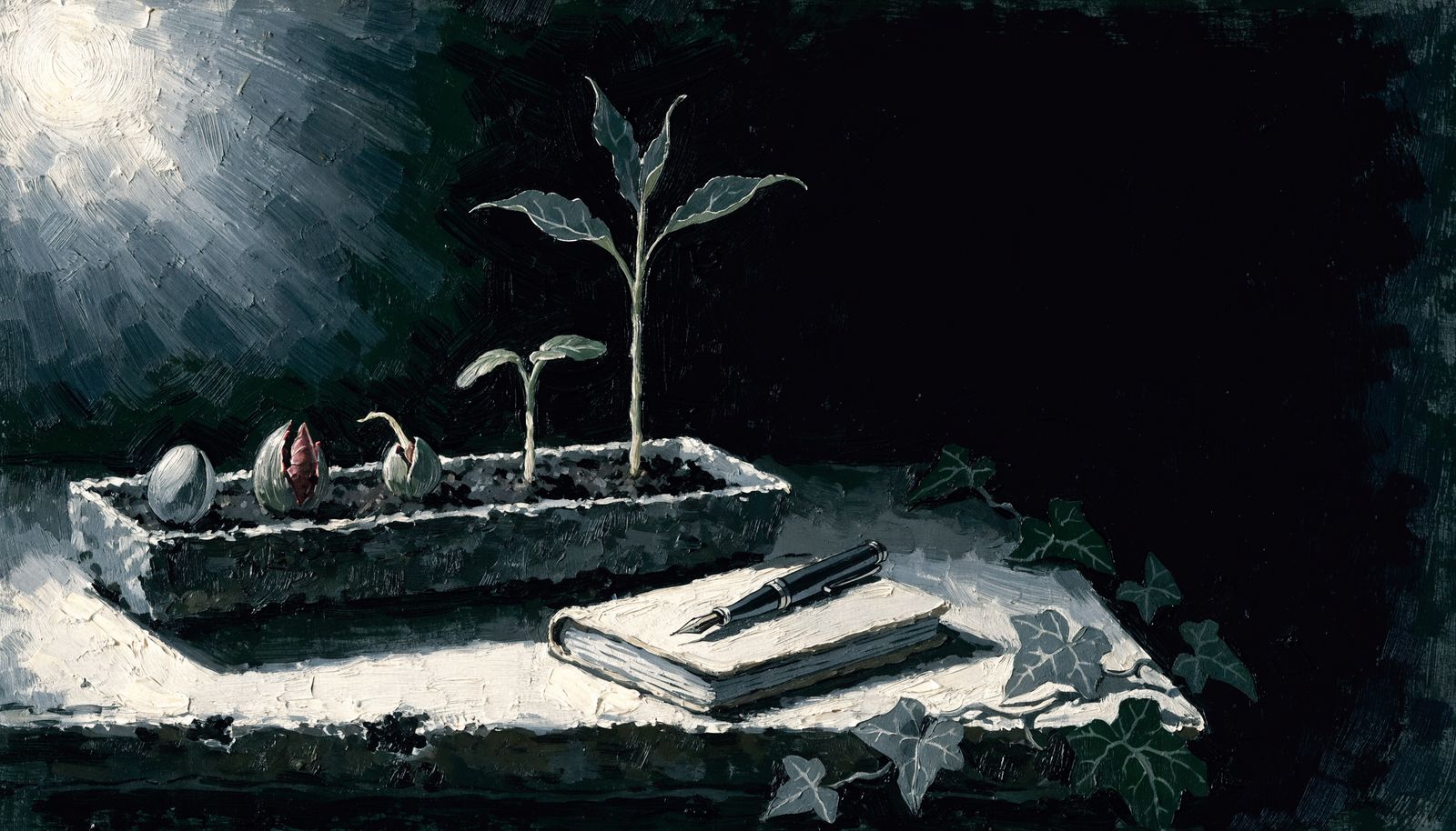 A stone planter of bulbs at different stages beside a closed notebook and pen
